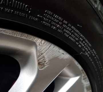 Alloy wheel with a curb rash damage