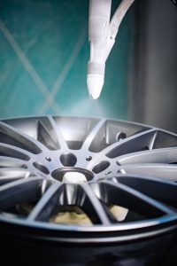 Car wheel being painted